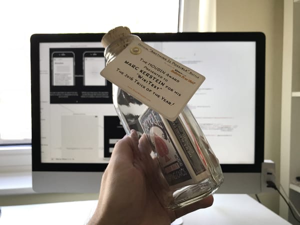 A deck of cards in a glass bottle with a label indicating WikiTest won the 2016 Trick Of The Year.